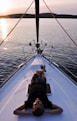 man lying on white boat