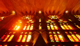 Sunlight streaming through the colorful stained glass windows of Sagrada Família.