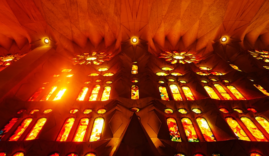 A vibrant congregation worshiping passionately under warm sunlight streaming through stained glass windows.