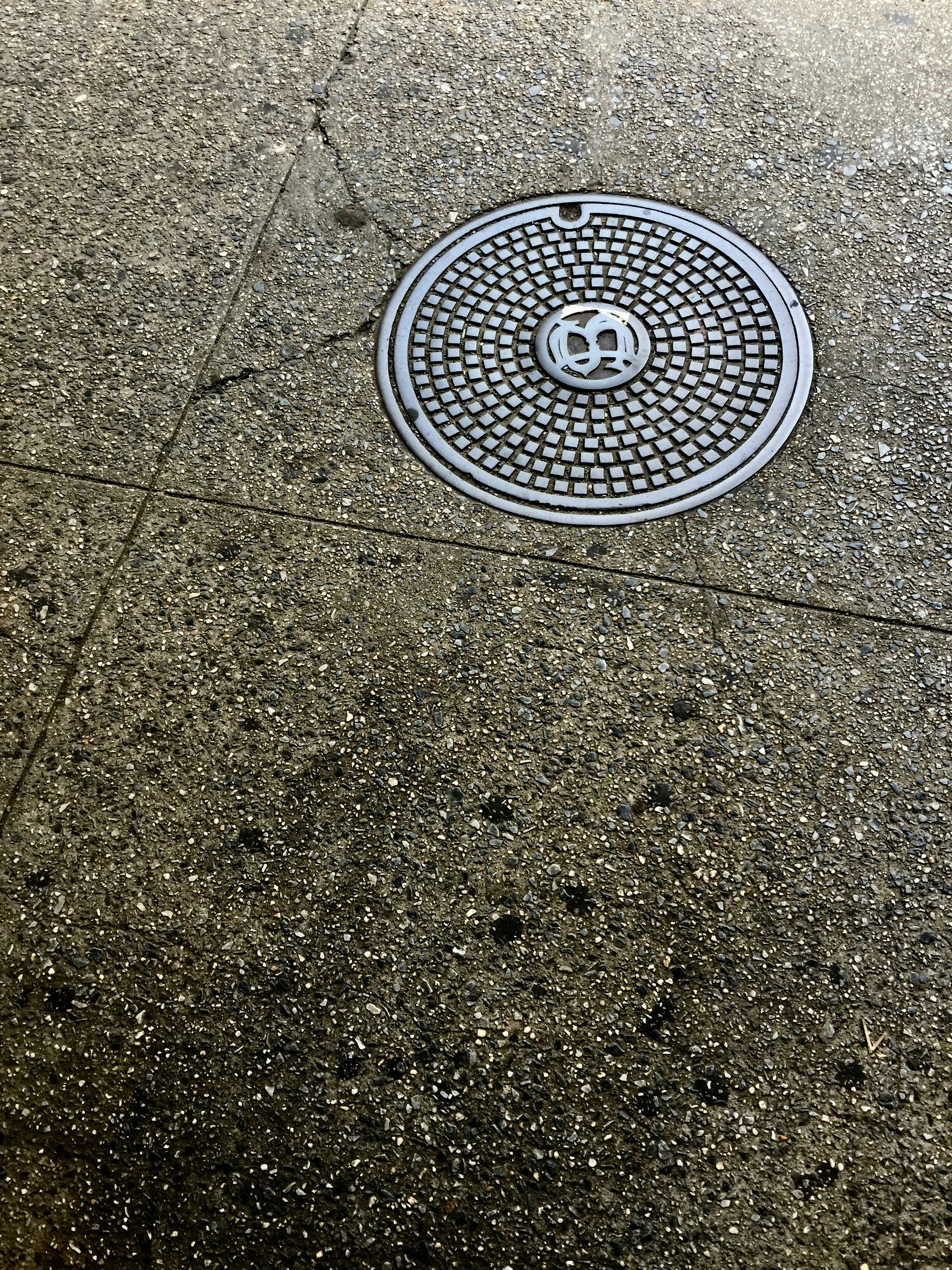 Concrete manhole cover in a road surface