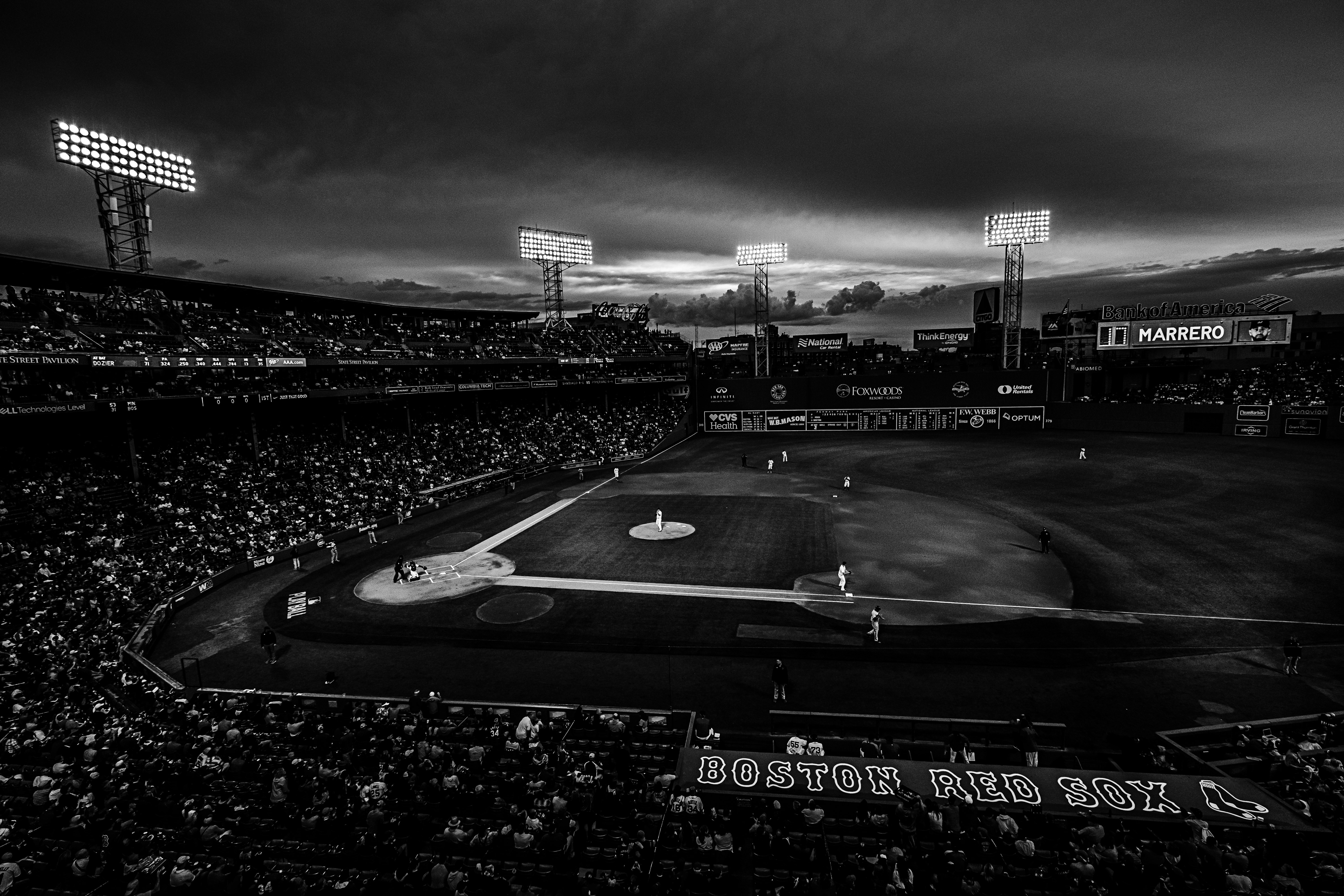grayscale photography of baseball field with people on bleachers
