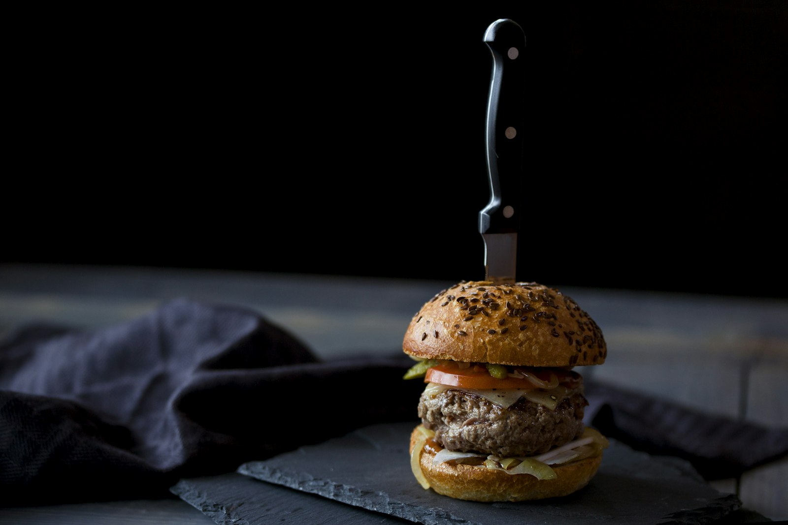 Canon EOS 5D Mark III + Sigma 105mm F2.8 EX DG OS HSM sample photo. Burger skewered with knife photography