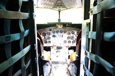 A sturdy flight bag packed with charts and pilot essentials on a cockpit seat.