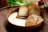 Close-up of a luxurious gourmet breakfast basket with beige and brown tones and minimalist design.