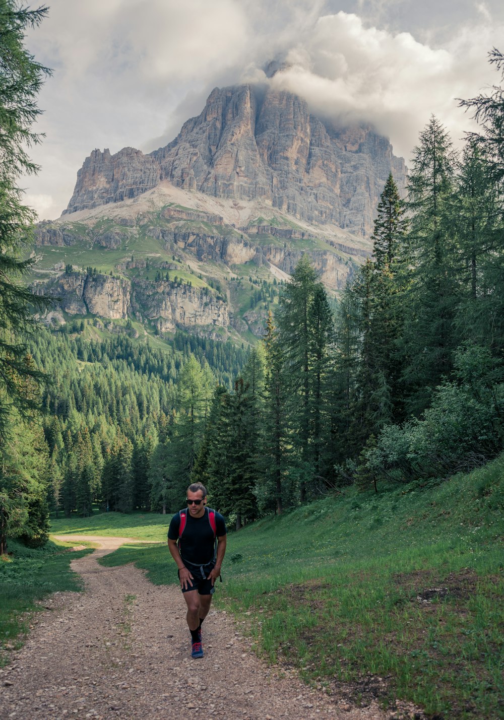 man walking on dirt trail