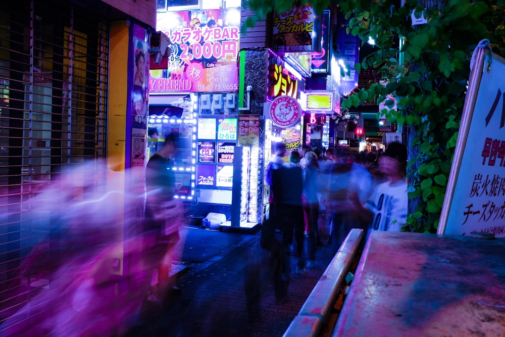 time lapse photo of people walking taken at nighttime
