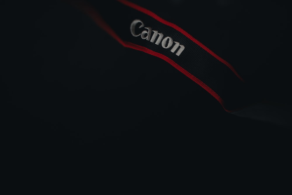 a close up of a canon logo on a black background