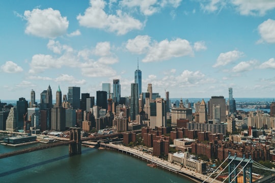 wide angle photo of Brooklyn Bridge under cloudy sky in Brooklyn Bridge Park United States