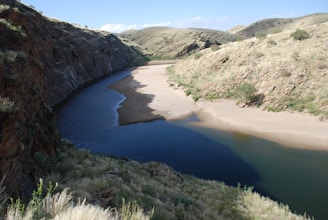 A serene view of a winding river through desert canyons.