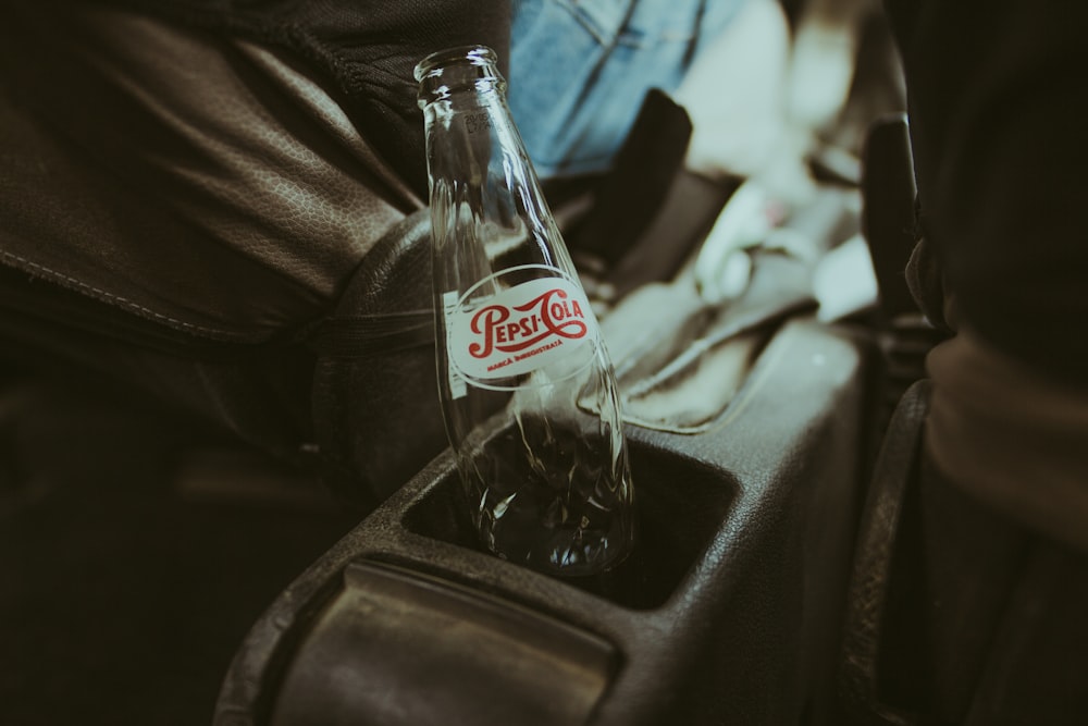 coca cola glass bottle on black textile