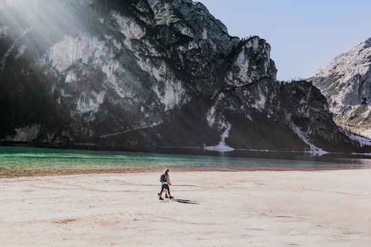 two people walks on beach in Parco naturale di Fanes-Sennes-Braies Italy