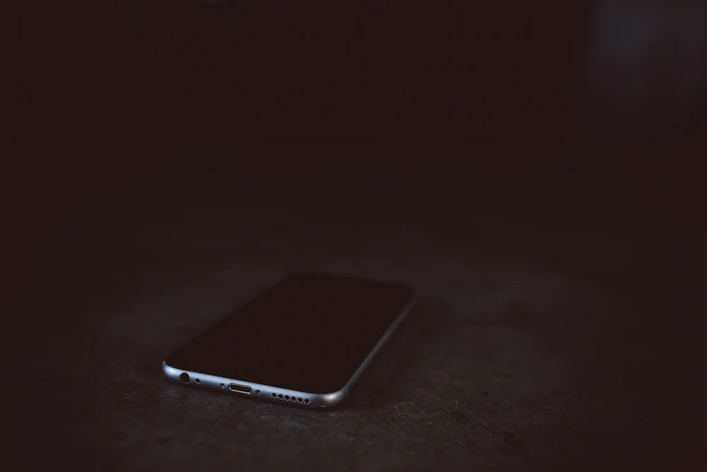 Mobile device on a dark desk
