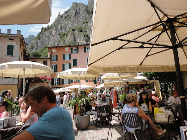 A bustling café terrace in Tanger filled with locals enjoying tea and conversation.