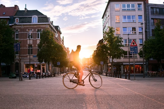 man riding bicycle on road during daytime in Leuven Belgium