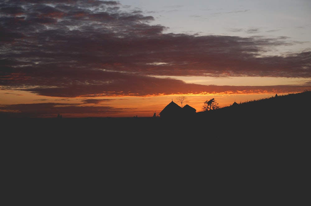 photo de silhouette de maison pendant le coucher du soleil