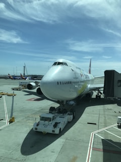 A large airplane at an airport, showcasing vibrant colors.