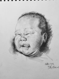 Playful drawing of a baby boy in mint green romper with stars and hearts.