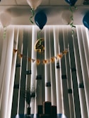A vibrant balloon arrangement featuring shadow art silhouettes celebrating a wedding anniversary.