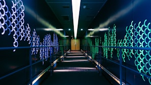 Corridor with brushed steel walls and subtle fire-inspired lighting accents.