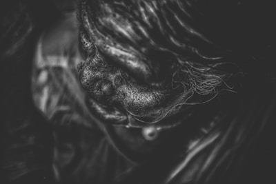 A black and white portrait of an elderly person showing deep lines and character.