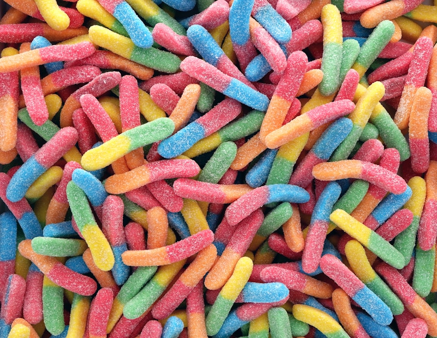 Close up of sour gummy worms, all brightly colored.