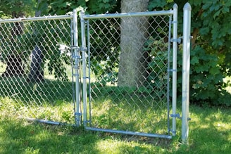 Custom chain-link gate with privacy slats, blending security with discretion in a residential setting.