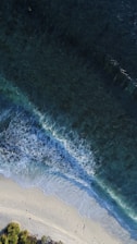 turquoise calm sea wave splashing on white sand beach aerial photography