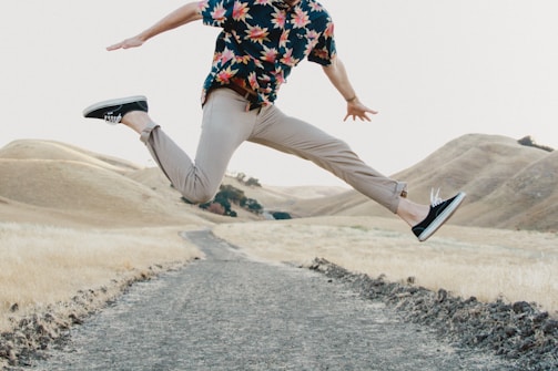 man in black shirt and gray pants jumping