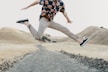 man in black shirt and gray pants jumping