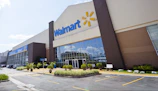 Exterior view of a Walmart store with customers entering.