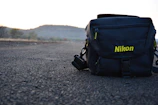 Rolling camera bag smoothly gliding over rugged terrain during a sunrise shoot.