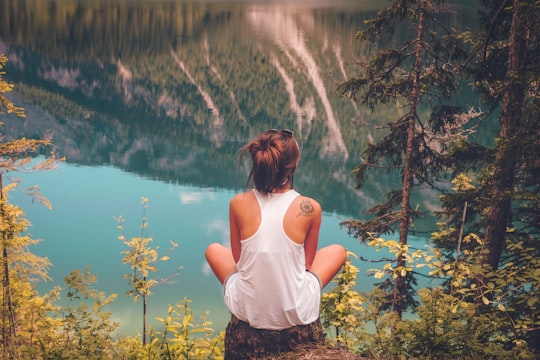 women's white tank top on top of the hill in Lago di Tovel Italy