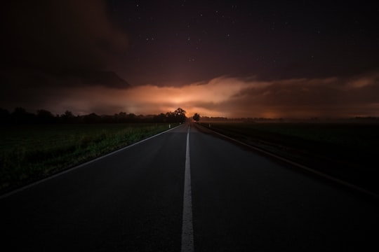 grey concrete road under cloudy sky during daytime in Irdning Austria