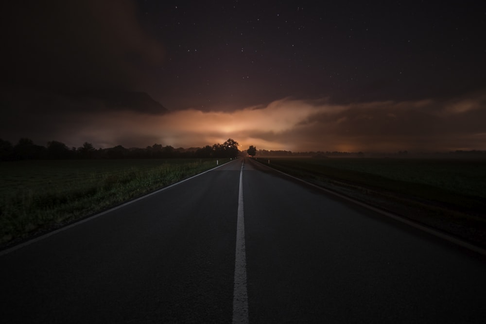 grey concrete road under cloudy sky during daytime