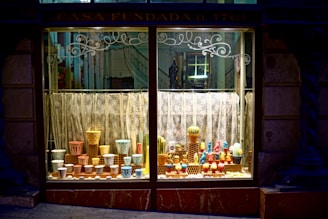 A bright, sunlit window display featuring burlapa’s jute home décor pieces.