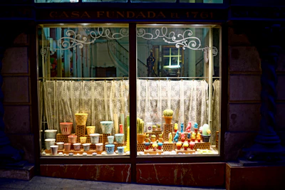 A vibrant display of potted plants nestled among vintage thrift items, showcasing the store’s unique charm.