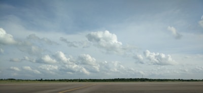 Open land plots with clear skies near the Noida International Airport runway.