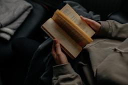 person reading book white sitting