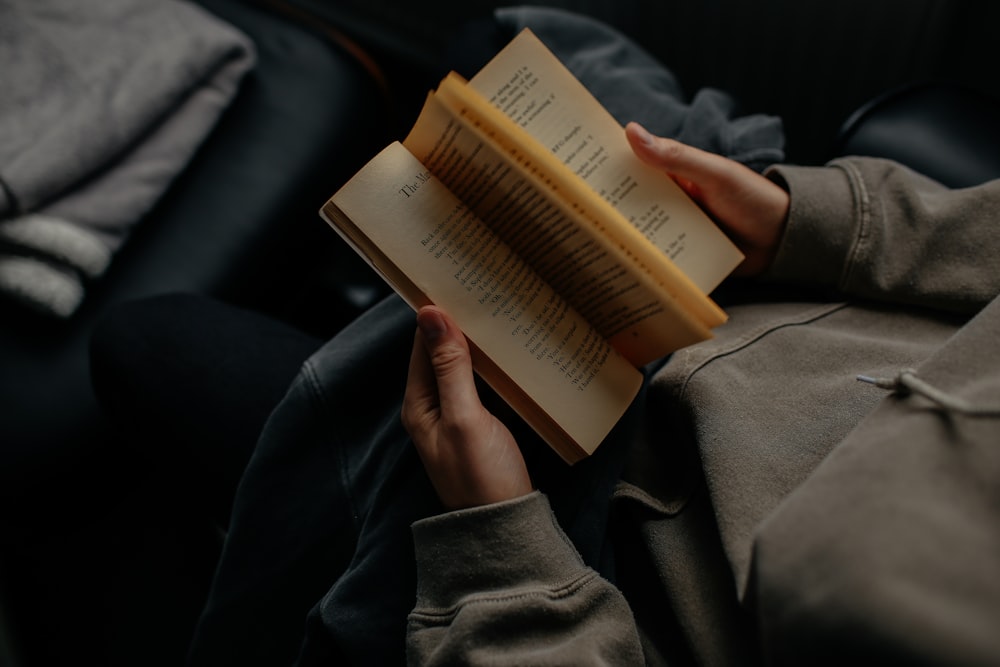 person reading book white sitting