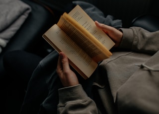 person reading book white sitting