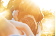 An intimate scene of two characters sharing a quiet, powerful moment in natural light.