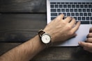 person wearing brown and white watch