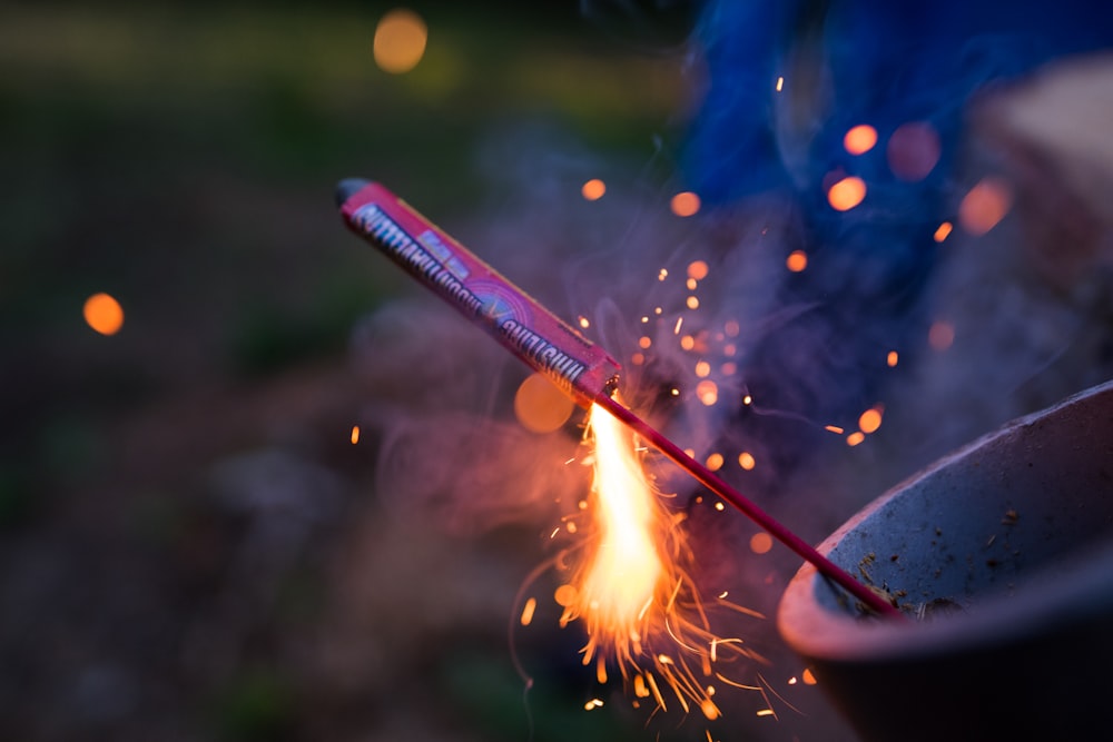 selective focus photography of lit firecracker