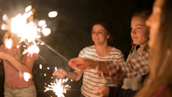 A group of kids at a party with vibrant fairy hair sparklez and joyful faces.