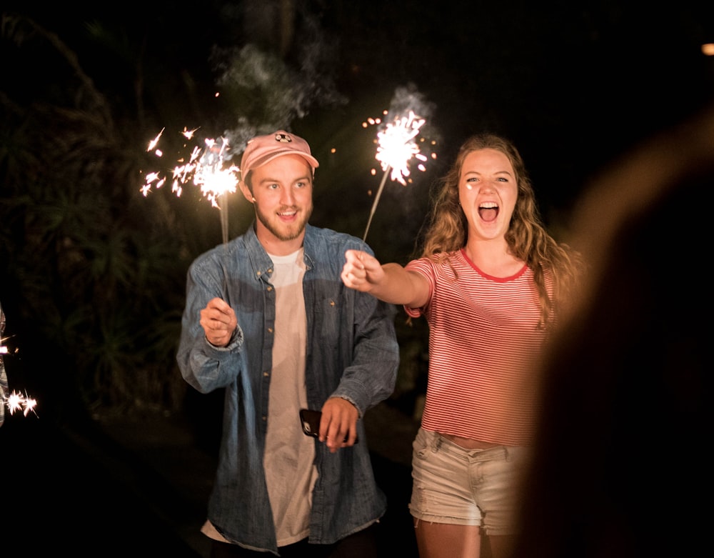 man and woman holding firecracker
