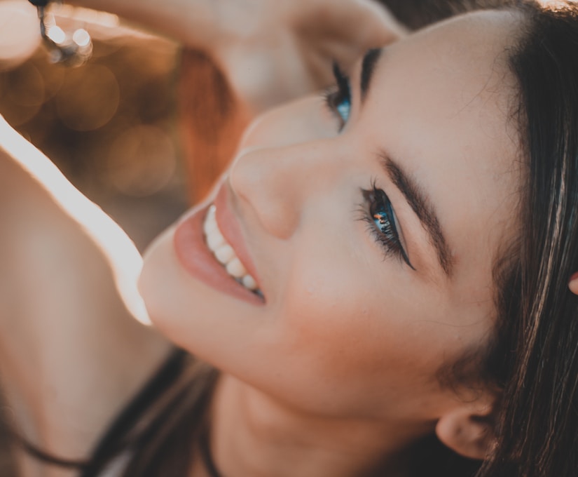 smiling woman with black hair and red lipstick