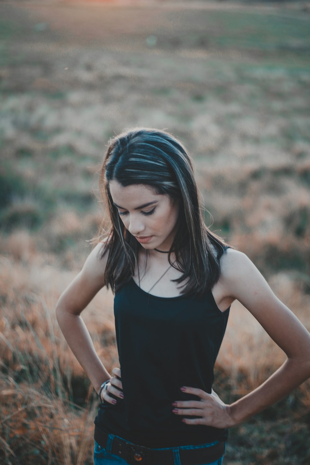 selective focus photography of woman standing at scenery