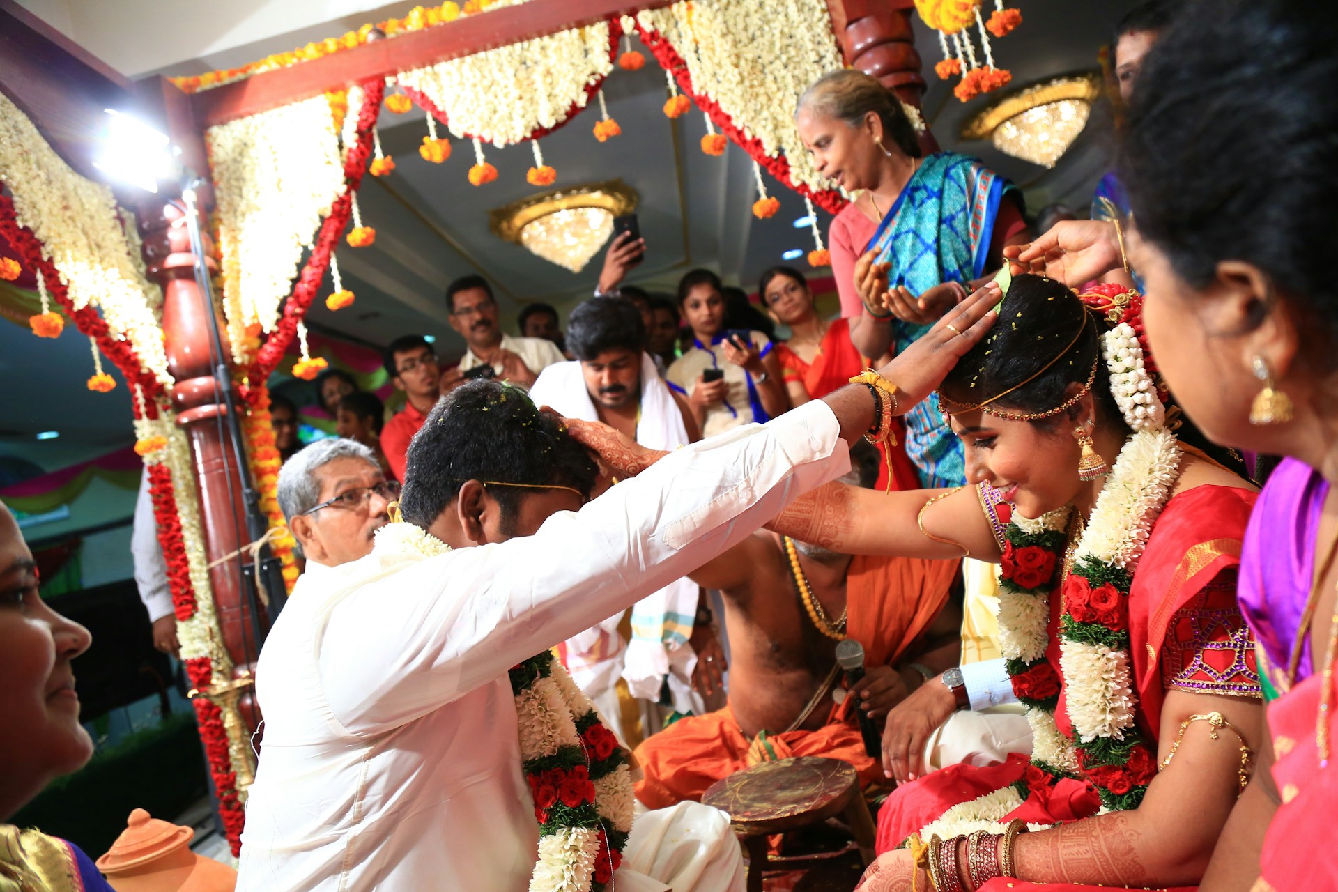 A stunning wedding ceremony captured in vibrant colors, showcasing the couple exchanging vows surrounded by loved ones.