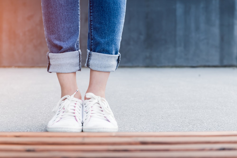 person wearing white low-top sneakers