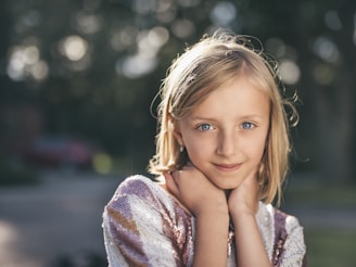 selective focus photography of girl in sequined white-and-pink stripe shirt